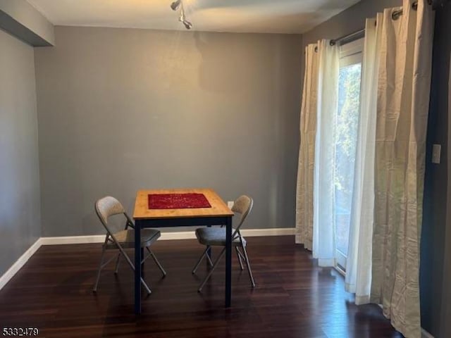 dining room with dark wood-type flooring