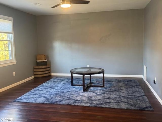 sitting room with ceiling fan and dark hardwood / wood-style floors