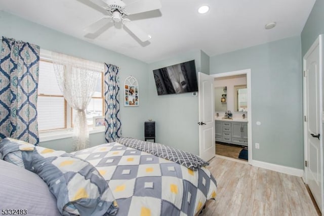 bedroom with connected bathroom, light hardwood / wood-style floors, and ceiling fan