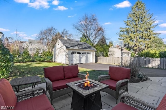 view of patio featuring a garage, an outdoor living space with a fire pit, and an outdoor structure