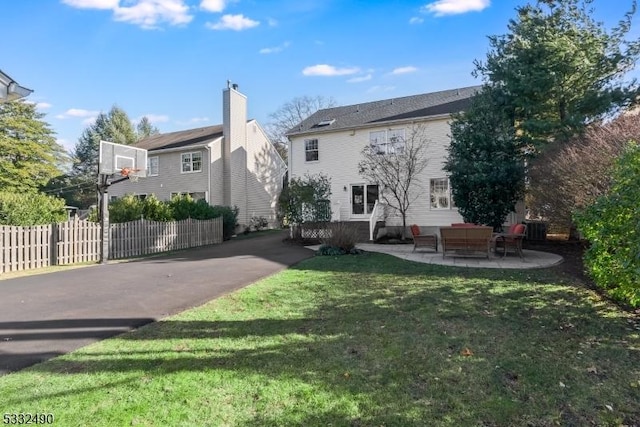 back of house featuring an outdoor hangout area, a patio, and a yard