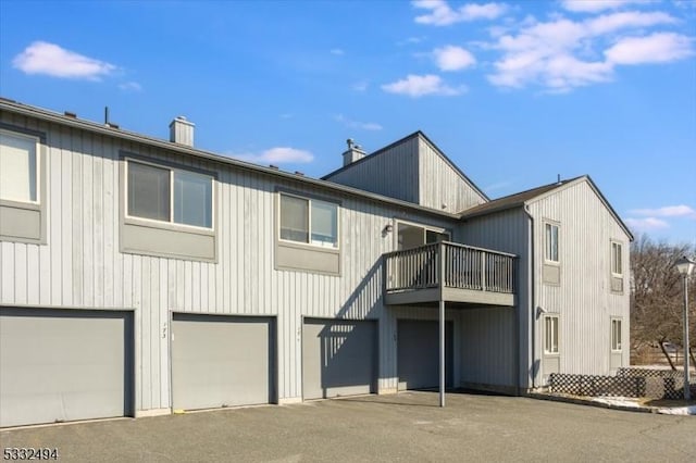 rear view of house featuring a garage