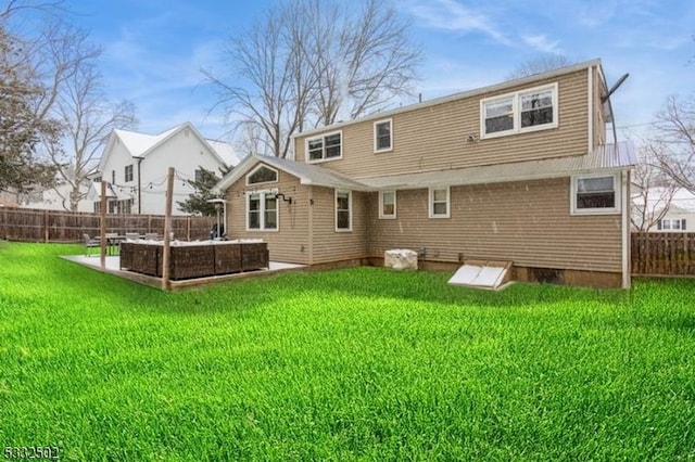 rear view of property with a yard and a patio