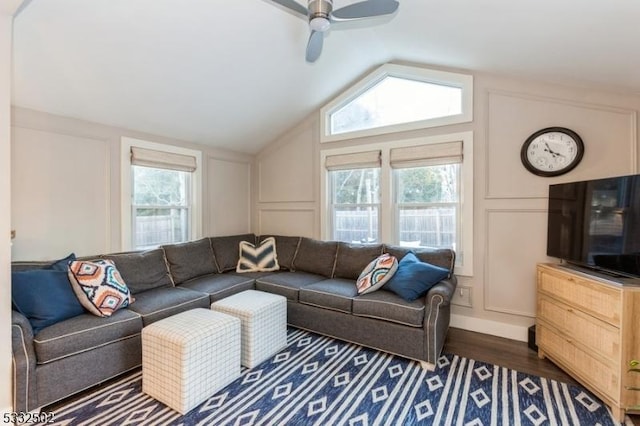 living room with lofted ceiling, ceiling fan, and dark hardwood / wood-style floors