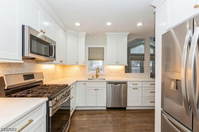 kitchen with sink, stainless steel appliances, white cabinets, and dark hardwood / wood-style floors