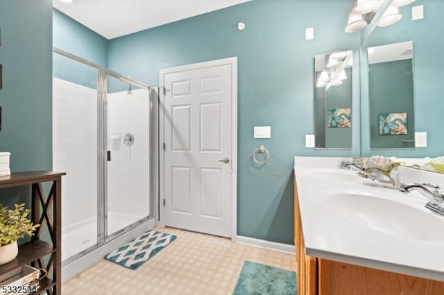 bathroom with a shower with door and vanity