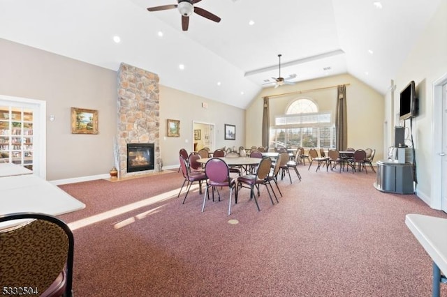 carpeted dining room featuring high vaulted ceiling, a fireplace, and ceiling fan