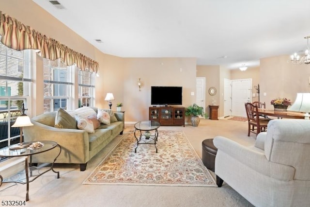 living room with a chandelier and light colored carpet