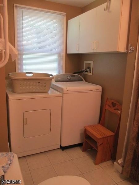 laundry room with separate washer and dryer and light tile patterned floors