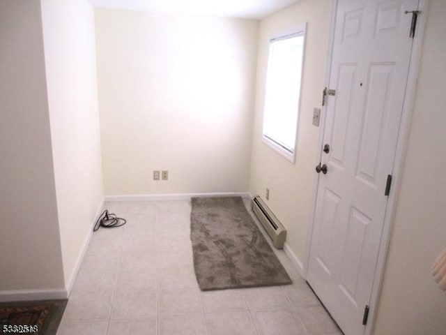 laundry area with a wealth of natural light and a baseboard radiator