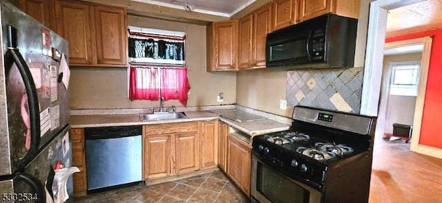 kitchen with appliances with stainless steel finishes, tasteful backsplash, and sink