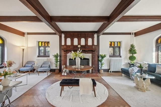 living room with beamed ceiling, parquet flooring, and radiator heating unit