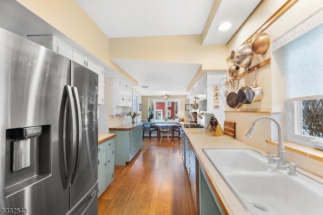 kitchen featuring dark hardwood / wood-style floors, sink, white cabinetry, and stainless steel appliances