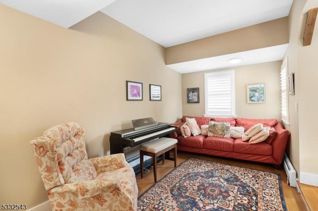 living room featuring light wood-type flooring and baseboard heating