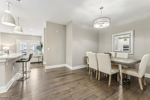 dining space featuring french doors, dark hardwood / wood-style floors, and sink