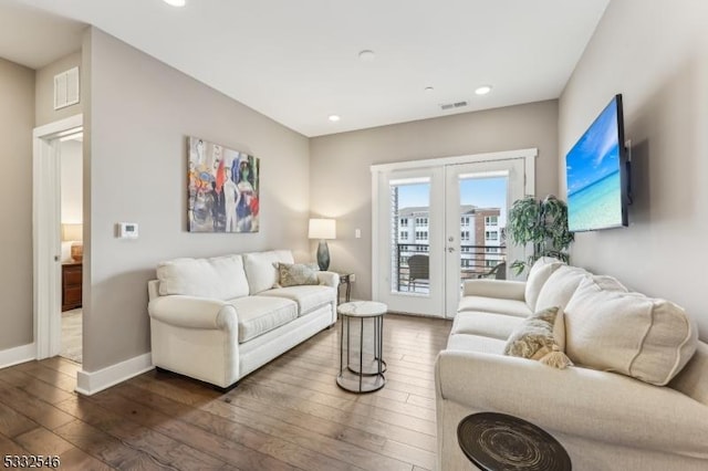 living room with dark hardwood / wood-style floors and french doors