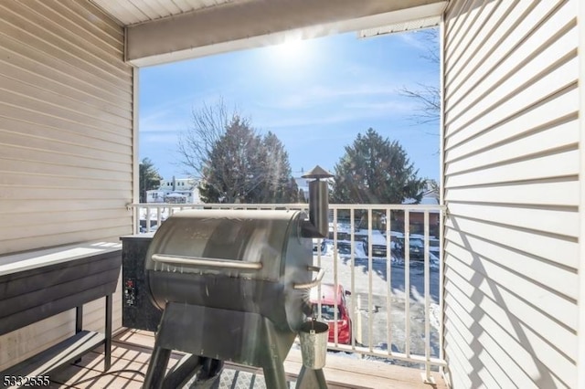 wooden terrace featuring a grill