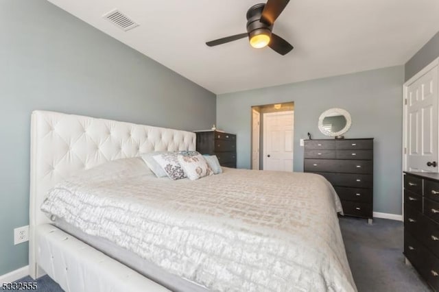 bedroom featuring ceiling fan and dark carpet