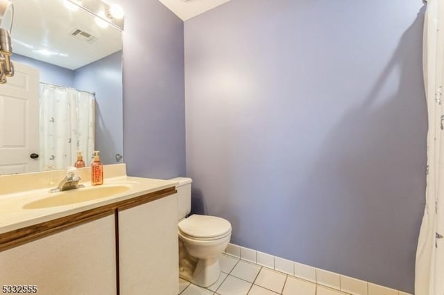 bathroom featuring vanity, toilet, and tile patterned flooring