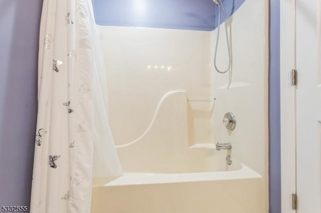 bathroom with shower / bath combination with curtain