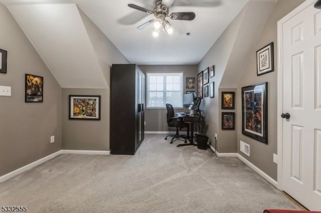 office space featuring ceiling fan, vaulted ceiling, and light carpet