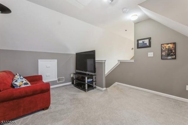 carpeted living room with vaulted ceiling