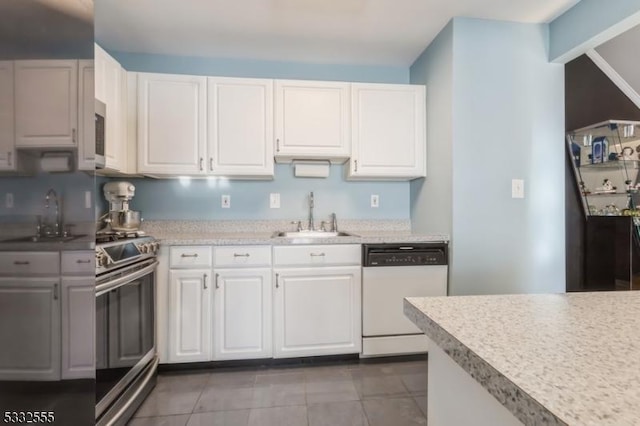 kitchen featuring white cabinetry, sink, stainless steel range oven, and white dishwasher