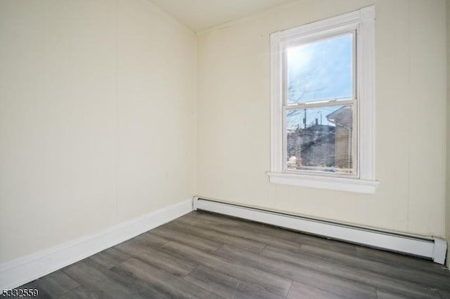 unfurnished room featuring a baseboard radiator and dark wood-type flooring