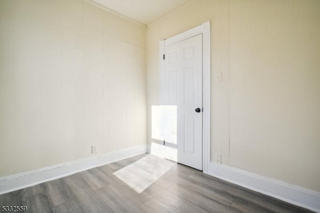 unfurnished room with dark hardwood / wood-style flooring