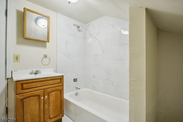 bathroom with shower / tub combination, vanity, and tile walls