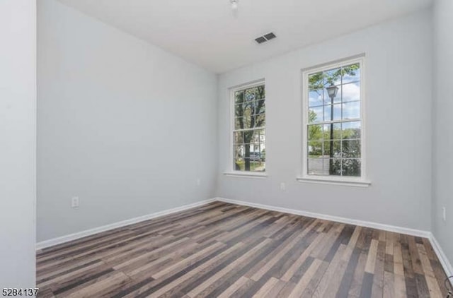 empty room with dark hardwood / wood-style floors