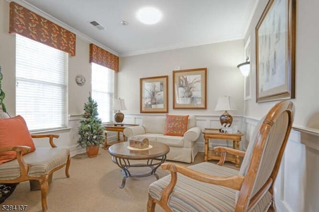 sitting room featuring carpet floors and ornamental molding