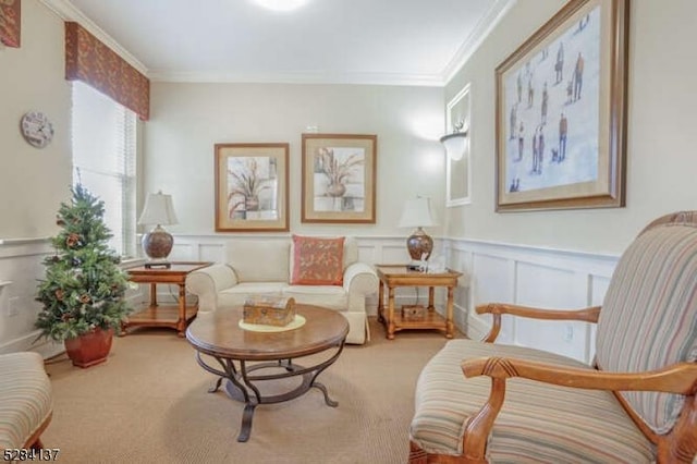 sitting room featuring light colored carpet and crown molding