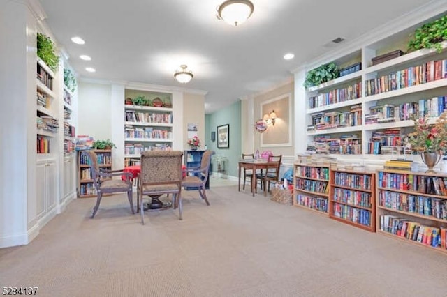 recreation room with ornamental molding, built in features, and carpet floors