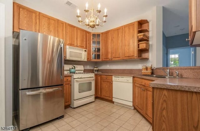 kitchen featuring decorative light fixtures, a notable chandelier, sink, white appliances, and light tile patterned flooring