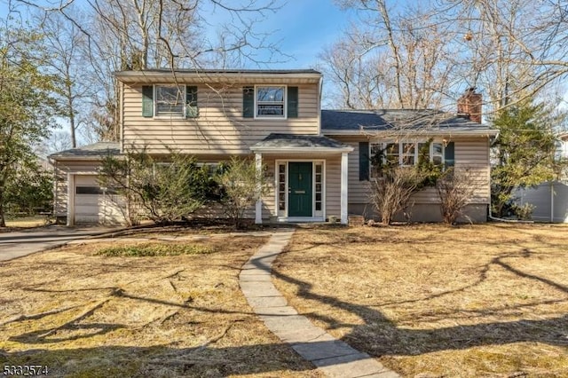 view of front of house featuring a garage and a front yard