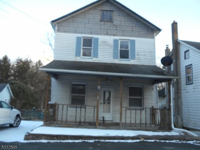 view of property featuring covered porch