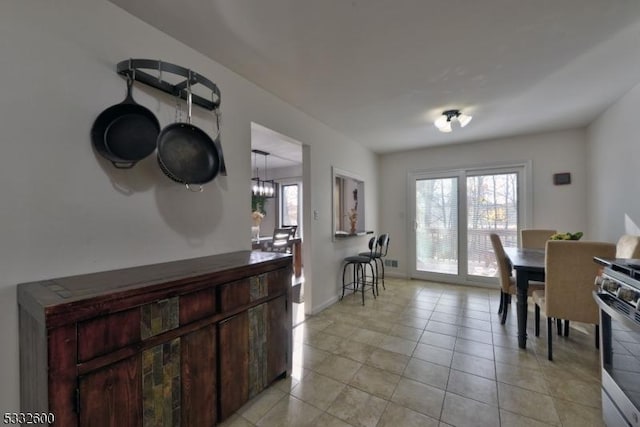 tiled dining room featuring a chandelier