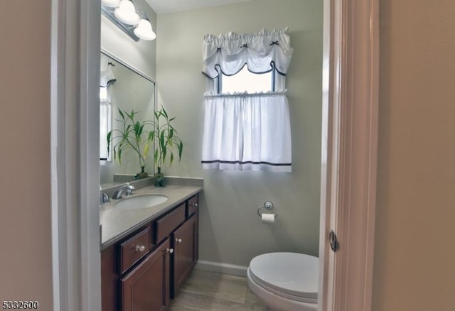 bathroom with toilet and vanity