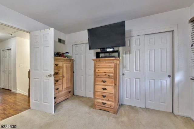 carpeted bedroom with multiple closets