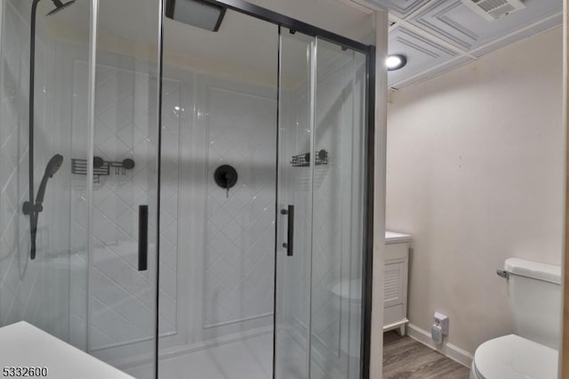 bathroom featuring hardwood / wood-style floors, toilet, and walk in shower