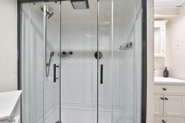 bathroom featuring crown molding, a shower with door, and vanity