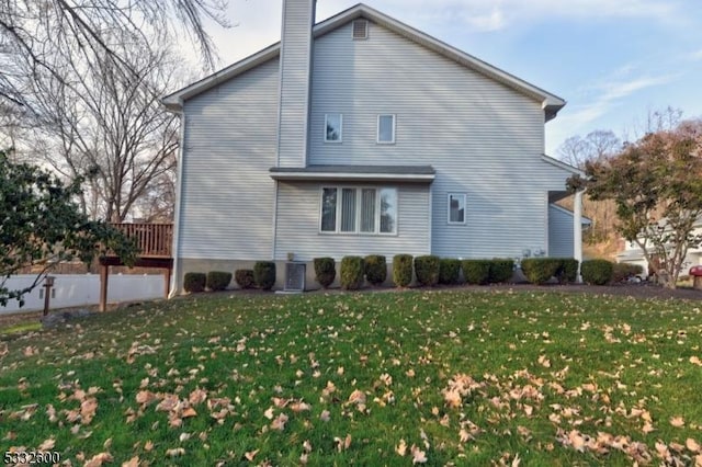 back of house featuring a lawn