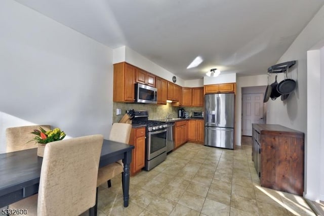 kitchen with stainless steel appliances and tasteful backsplash