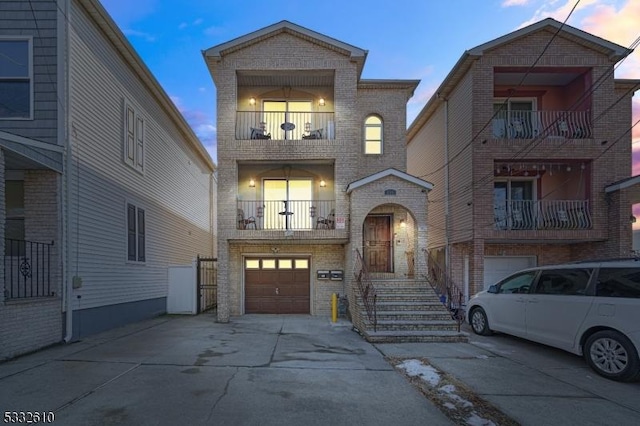 view of front facade with a balcony and a garage