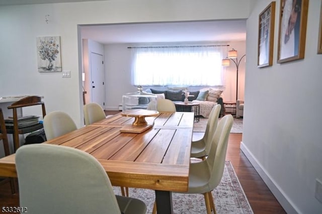 dining room with dark hardwood / wood-style flooring