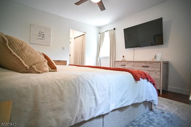 bedroom featuring ceiling fan and dark wood-type flooring