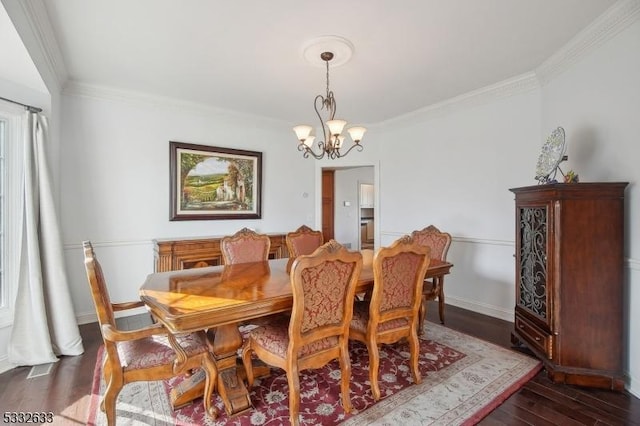 dining space featuring a notable chandelier, crown molding, and dark wood-type flooring