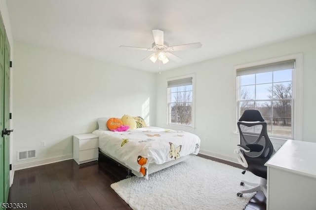 bedroom with dark hardwood / wood-style flooring and ceiling fan