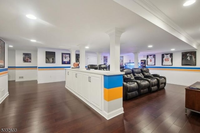 interior space with ornamental molding, dark hardwood / wood-style flooring, and ornate columns